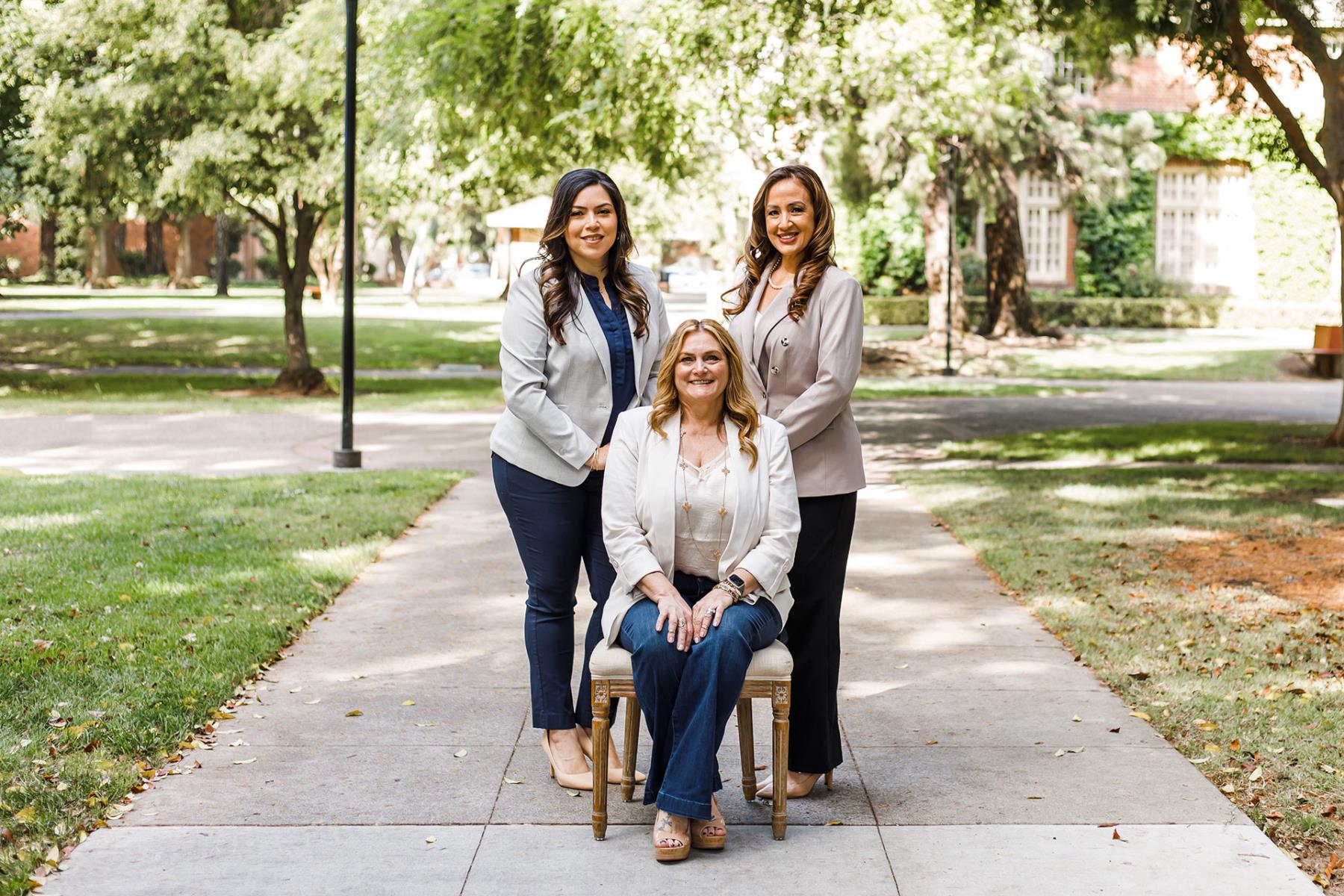 Three females smiling at camera
